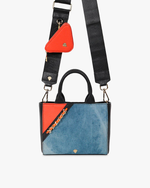 Bag with denim shoulder strap and orange accessory